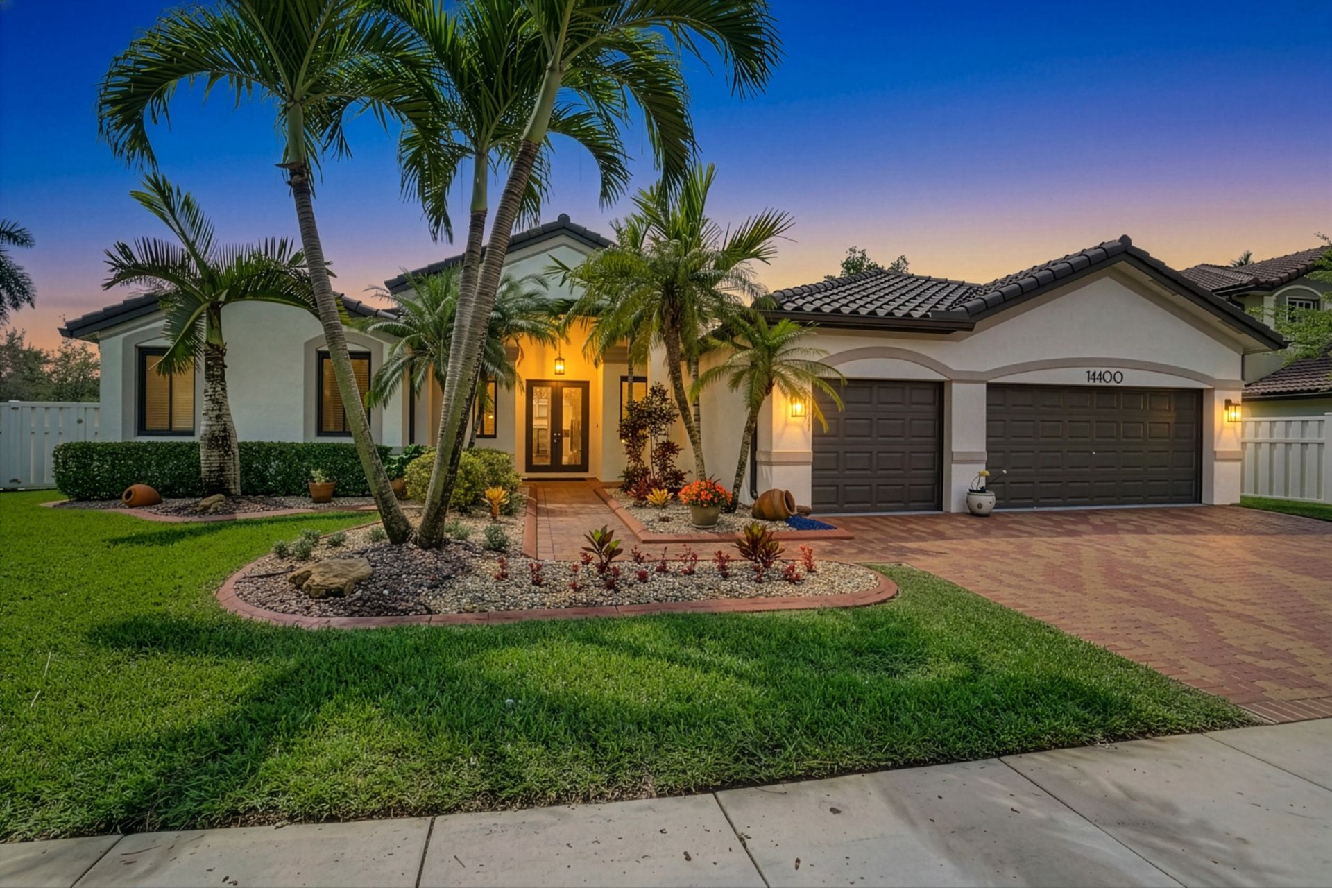 Day-to-twilight conversion: dusk front exterior with warm entry and window lights