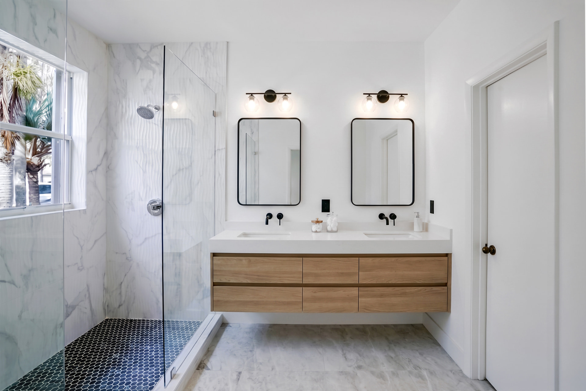 After virtual staging: finished primary bathroom with floating oak double vanity, mirrors and sconces